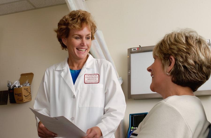 A physician in a white coat speaking with a patient
