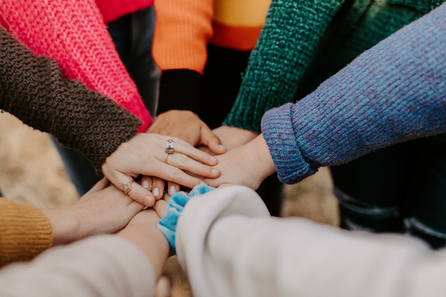 A group of community members joining hands together in a circle